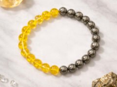 Citrine pyrite bracelet flat lay on marble background