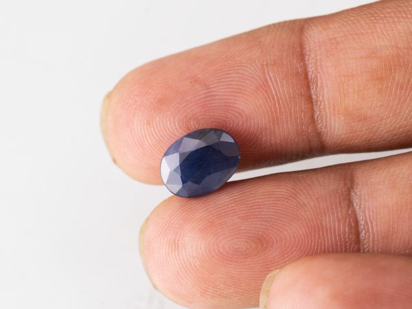 Neelam loose gemstone 4.39 carat in hand size reference