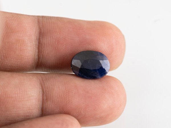 Neelam loose gemstone 7.14 carat in hand size reference