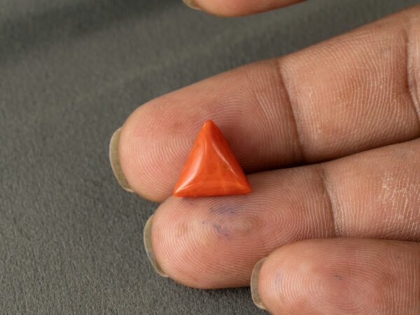 Italian red coral moonga 5.15 carat in hand size reference