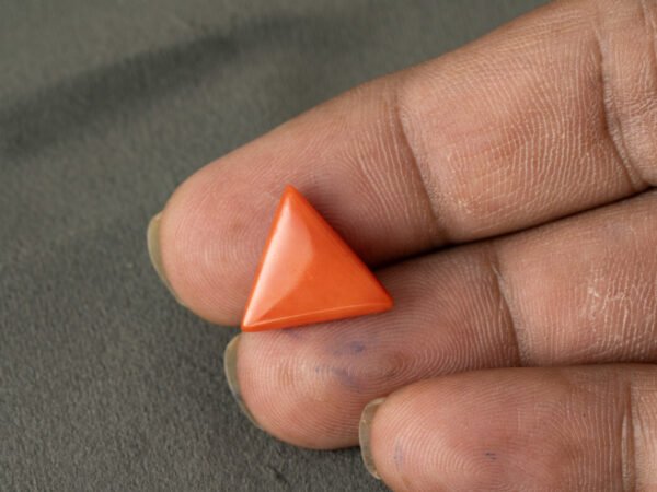 Italian red coral moonga 5.24 carat in hand size reference