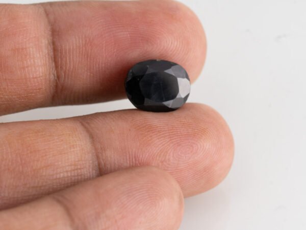 natural black tourmaline 4.78 carat in hand size reference