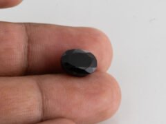 natural black tourmaline 5.88 carat in hand size comparison