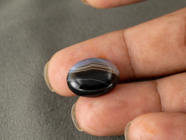 Sulemani Hakik 10.79 Carat in-hand size reference 18.4 x 14.2 mm