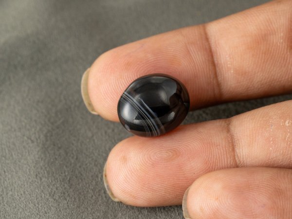 Sulemani Hakik 11.88 Carat in-hand size reference 16.7 x 13.5 mm