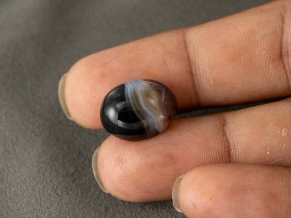 Sulemani Hakik 12.45 Carat in-hand size reference 17.1 x 13.5 mm