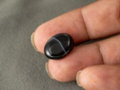 Sulemani Hakik 7.66 Carat in-hand size reference 17.5 x 13.2 mm