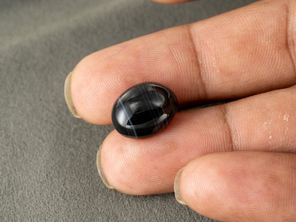 Sulemani Hakik 9.08 Carat in-hand size reference 15.2 x 12.2 mm