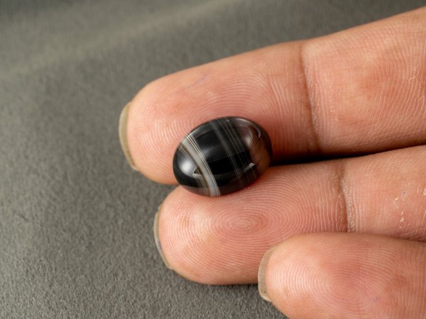 Sulemani Hakik 9.38 Carat in-hand size reference 15.6 x 11.8 mm