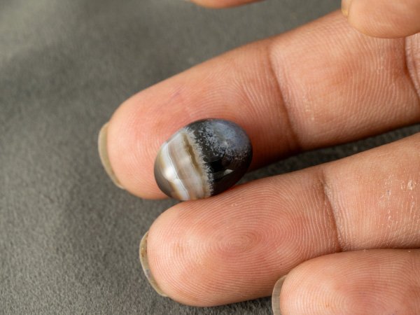 Sulemani Hakik 9.61 Carat in-hand size reference 16 x 12.3 mm