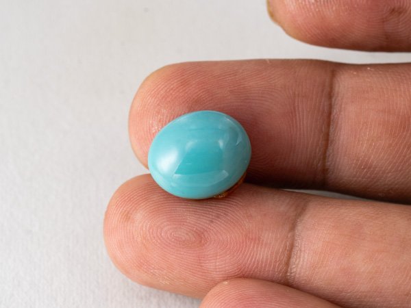 American firoza 10.16 carat turquoise in hand size reference