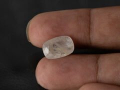 natural white sapphire Safed Pukhraj 8.08 carat in hand scale