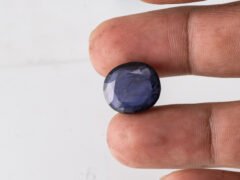 Natural Kaka Neeli Stone Iolite 10.13 carat in hand size reference