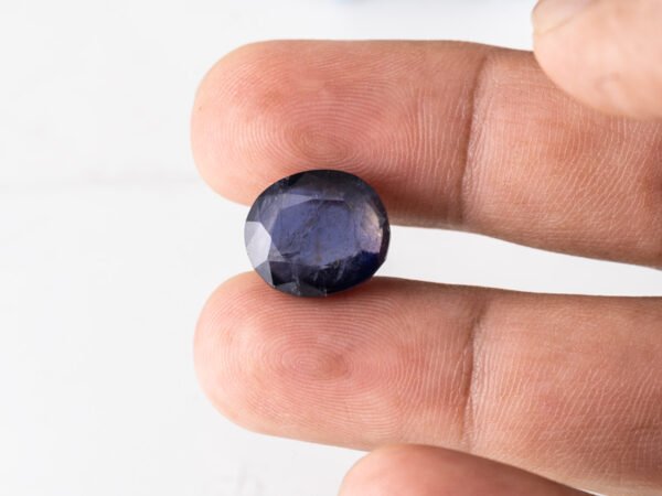 Natural Kaka Neeli Stone Iolite 10.16 carat in hand size reference