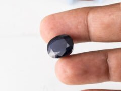 Natural Kaka Neeli Stone Iolite 10.91 carat in hand size reference