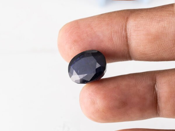 Natural Kaka Neeli Stone Iolite 10.91 carat in hand size reference
