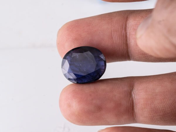 Natural Kaka Neeli Stone Iolite 11.38 carat in hand size reference