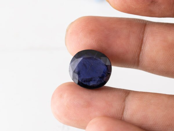 Natural Kaka Neeli Stone Iolite 12.65 carat in hand size reference