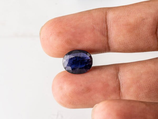 Natural Kaka Neeli Stone Iolite 4.29 carat in hand size reference