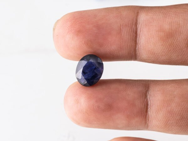 Natural Kaka Neeli Stone Iolite 4.31 carat in hand size reference