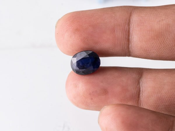 Natural Kaka Neeli Stone Iolite 4.36 carat in hand size reference