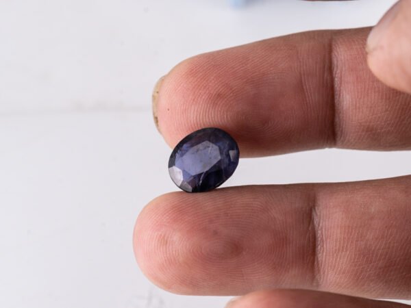 Natural Kaka Neeli Stone Iolite 4.41 carat in hand size reference