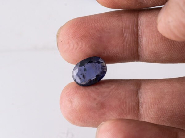 Natural Kaka Neeli Stone Iolite 4.53 carat in hand size reference