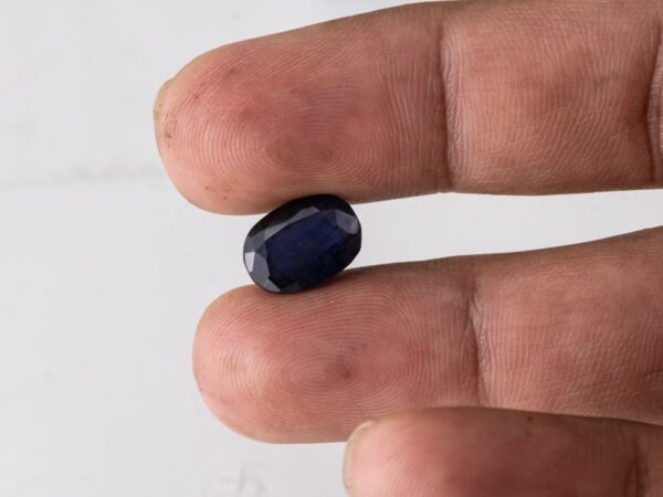 Natural Kaka Neeli Stone Iolite 4.94 carat in hand size reference