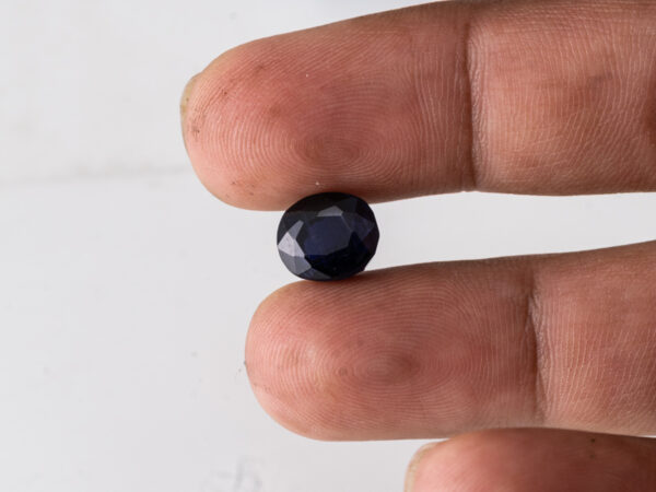Natural Kaka Neeli Stone Iolite 5.17 carat in hand size reference