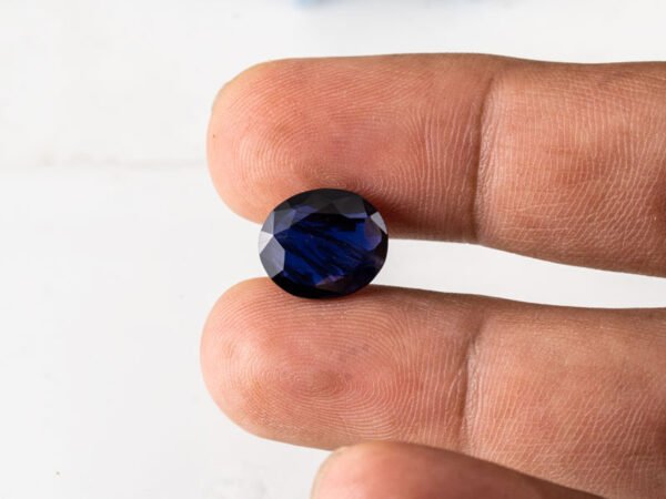 Natural Kaka Neeli Stone Iolite 5.60 carat in hand size reference