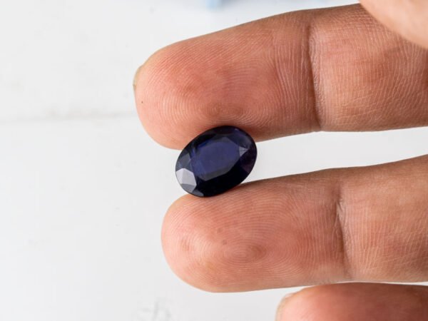Natural Kaka Neeli Stone Iolite 5.78 carat in hand size reference