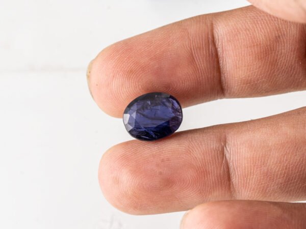 Natural Kaka Neeli Stone Iolite 5.79 carat in hand size reference