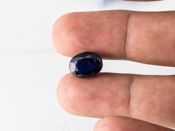 Natural Kaka Neeli Stone Iolite 5.96 carat in hand size reference