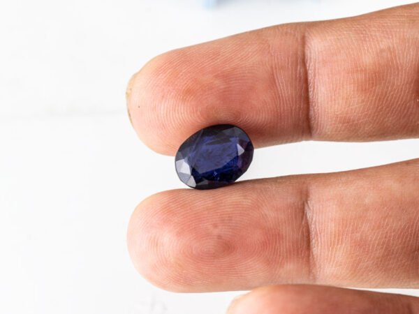 Natural Kaka Neeli Stone Iolite 6.10 carat in hand size reference