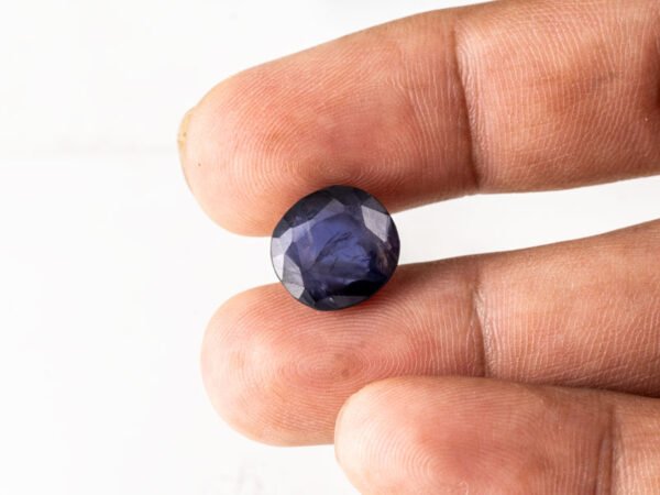 Natural Kaka Neeli Stone Iolite 6.21 carat in hand size reference