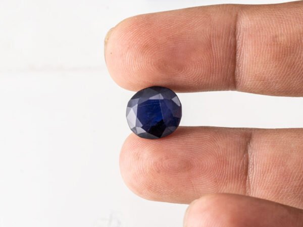 Natural Kaka Neeli Stone Iolite 6.26 carat in hand size reference