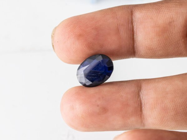 Natural Kaka Neeli Stone Iolite 6.41 carat in hand size reference