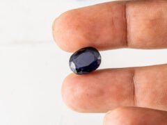 Natural Kaka Neeli Stone Iolite 6.80 carat in hand size reference