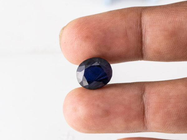 Natural Kaka Neeli Stone Iolite 7.04 carat in hand size reference