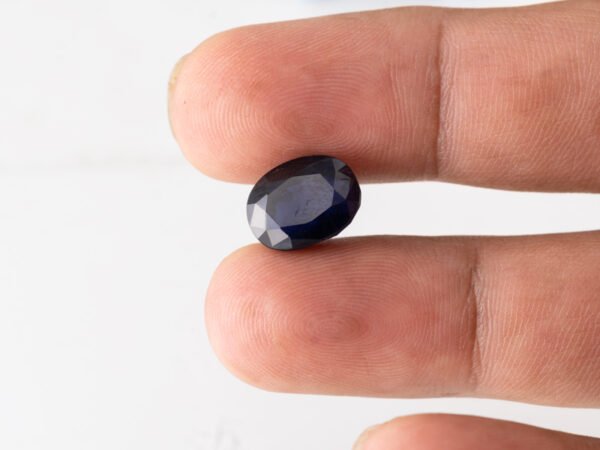 Natural Kaka Neeli Stone Iolite 7.04 carat in hand size reference