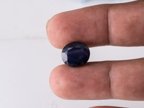 Natural Kaka Neeli Stone Iolite 7.26 carat in hand size reference