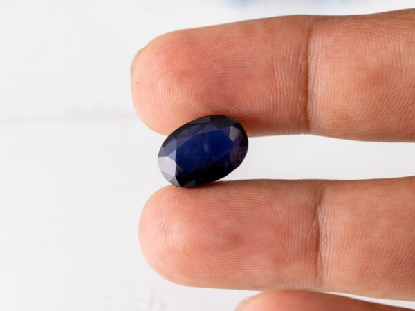Natural Kaka Neeli Stone Iolite 7.34 carat in hand size reference