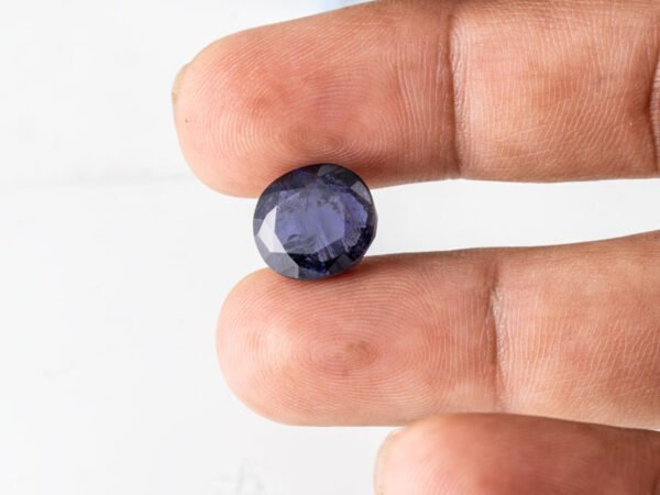 Natural Kaka Neeli Stone Iolite 7.61 carat in hand size reference