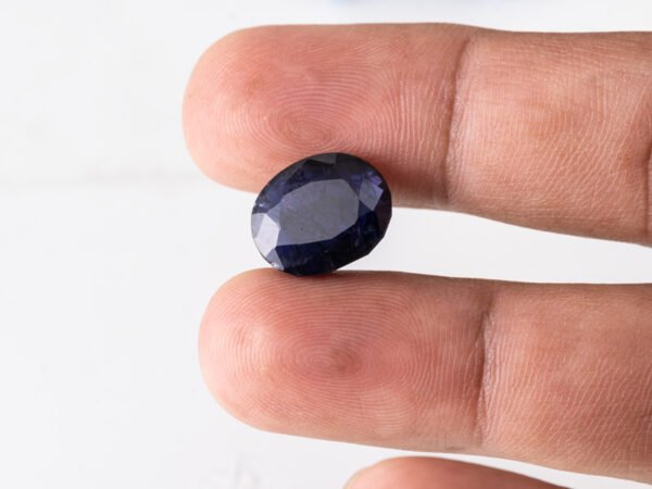 Natural Kaka Neeli Stone Iolite 7.66 carat in hand size reference