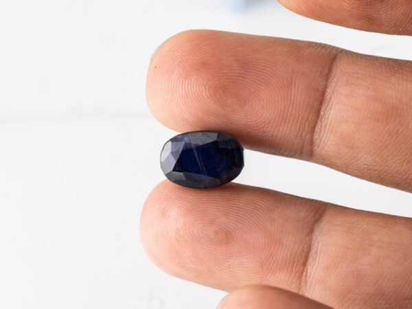 Natural Kaka Neeli Stone Iolite 7.71 carat in hand size reference