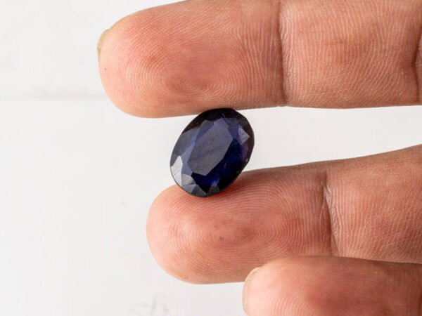 Natural Kaka Neeli Stone Iolite 8.38 carat in hand size reference