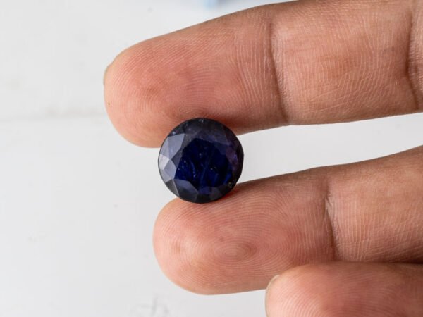 Natural Kaka Neeli Stone Iolite 8.41 carat in hand size reference