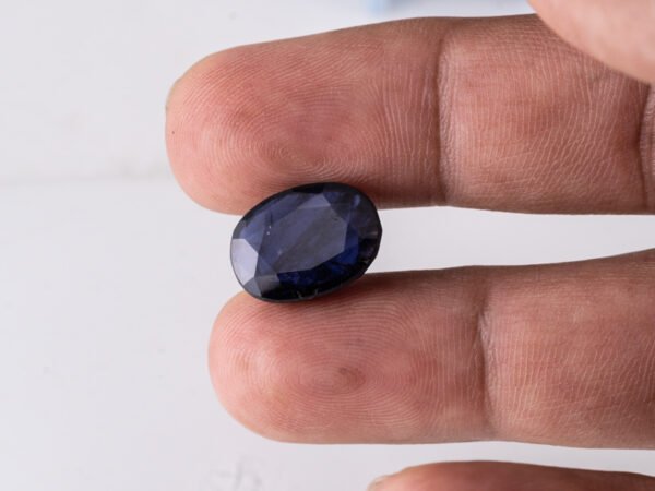 Natural Kaka Neeli Stone Iolite 8.86 carat in hand size reference