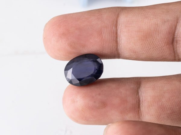 Natural Kaka Neeli Stone Iolite 9.03 carat in hand size reference