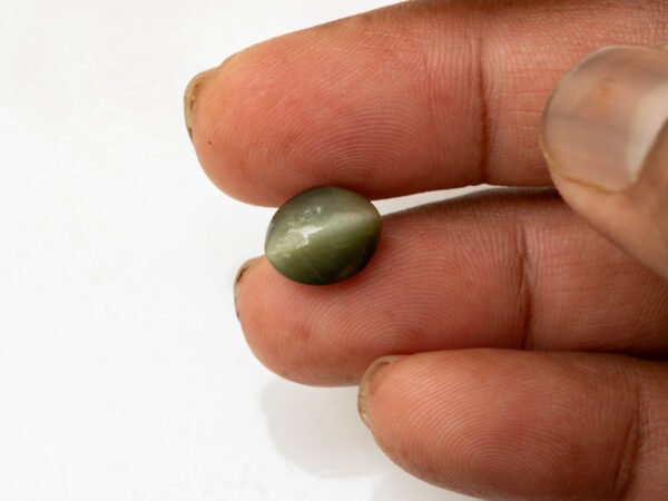 Quartz Cat's Eye Lahsuniya 5.28 carat in-hand actual size